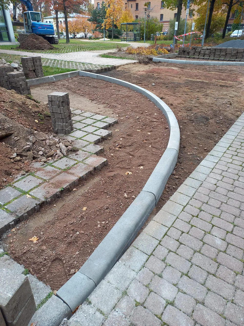 Außenanlage mit Pflastersteinen und Bordsteinen in einer Gartenanlage